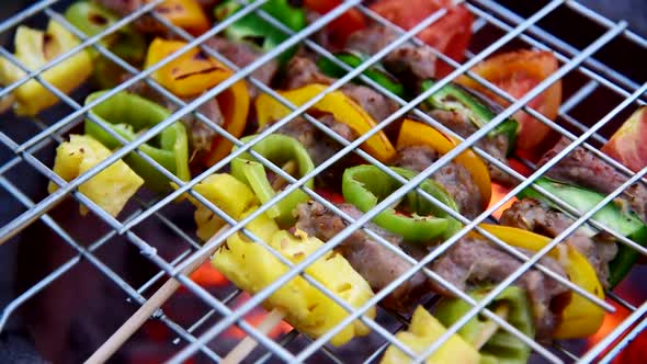 Grill the pork barbecue with fire on the stove alt