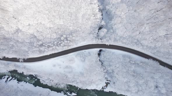 Aerial Top Down Cinematic Winter Snow Cowered Country Road Asphalt Serpentine