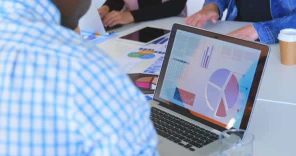 Young black male executive using laptop in modern office 4k alt