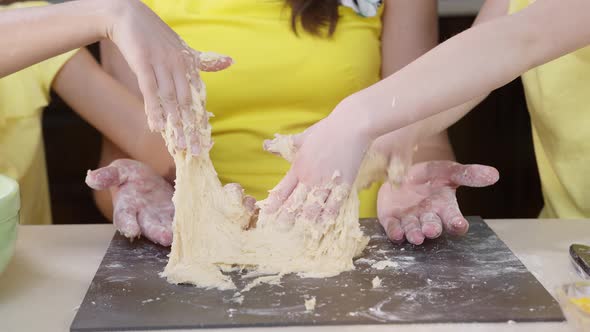 Children's Hands Close Up Knead Pizza Dough. Children Help Their Mother To Cook alt