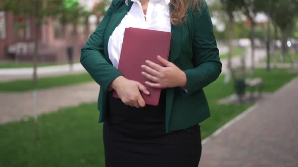 Unrecognizable Nervous Worried Plussize Caucasian Woman Standing on City Street with Laptop Waiting alt