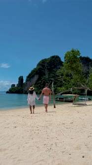 Couple Men and Woman on the Beach of Koh Hong Island Krabi Thailand Asian Woman and European Men on alt