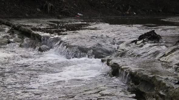 Flowing clear river water stream. Rapid river with water fall alt