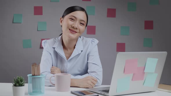 Asian woman happy working office smilling and looking at camera.