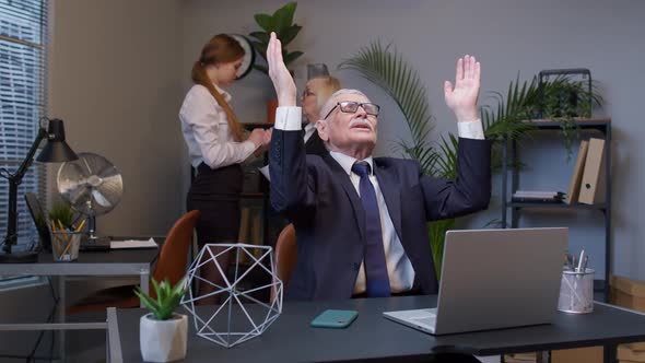 Mature Elderly Freelancer Man Praying to God Looking Upward and Making Wish Good Luck in Office alt