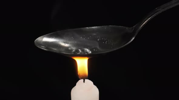 Cooking Heroin on a Spoon Over the Flame of Candle. Prepares a Dose. Hard Drugs alt