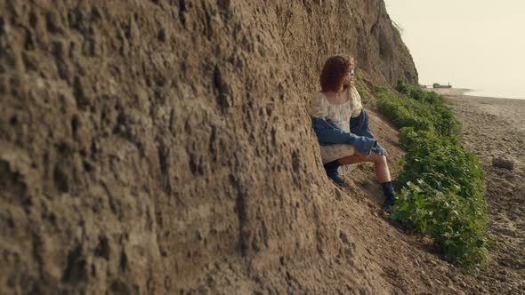 Stylish Girl Sitting Beach Lean on Sand Hill alt