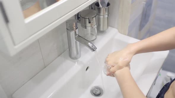 A Girl Washes Her Hands During an Epidemic