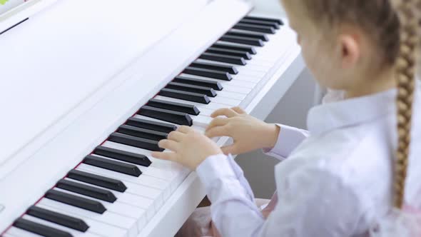Little Girl Plays Classical Music on a Piano