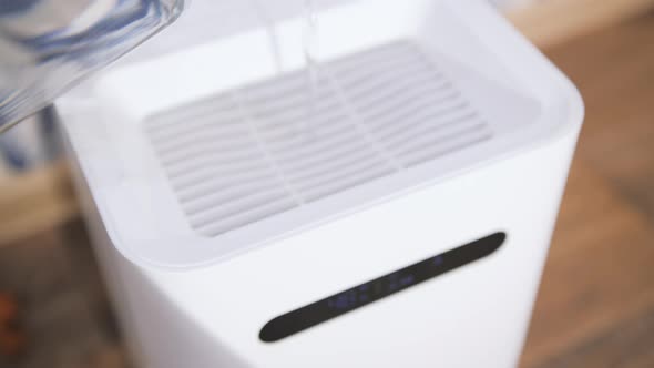 Pouring Water Into Air Wash Cleaner Closeup