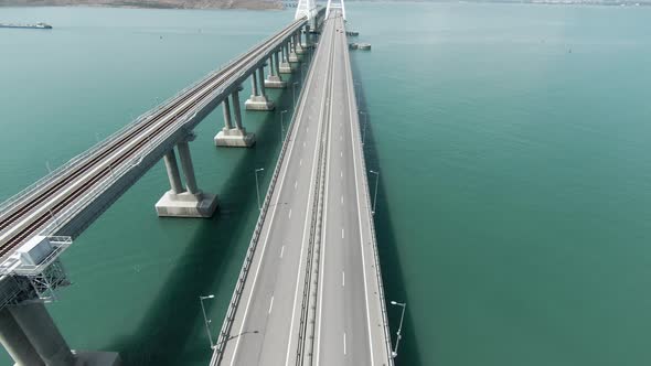 Aerial View of a Bridge Over the Sea with Calm Water alt