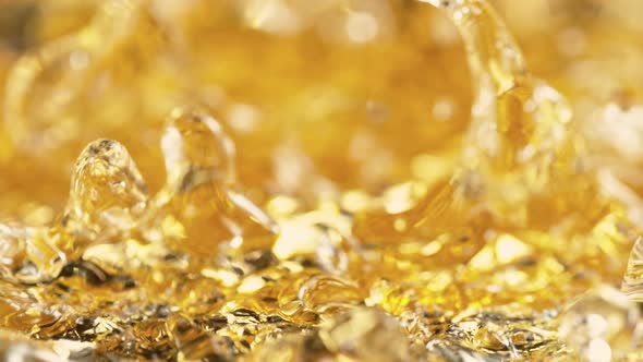 Super Slow Motion Shot of Waving Golden Liquid at 1000Fps alt