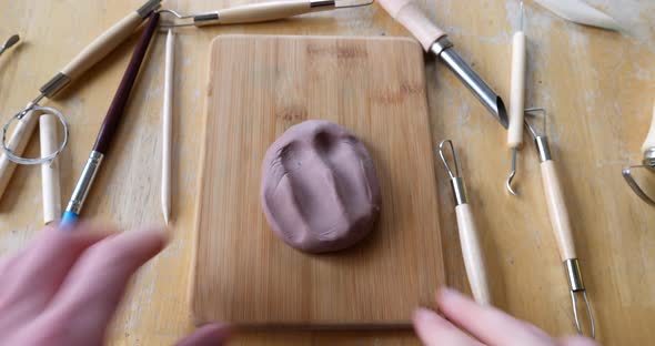 A frustrated, perfectionist artist destroying his sculpture and starts over with a fresh piece of br alt