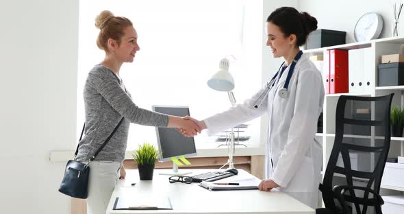 Doctor and Patient Shake Hands in Office