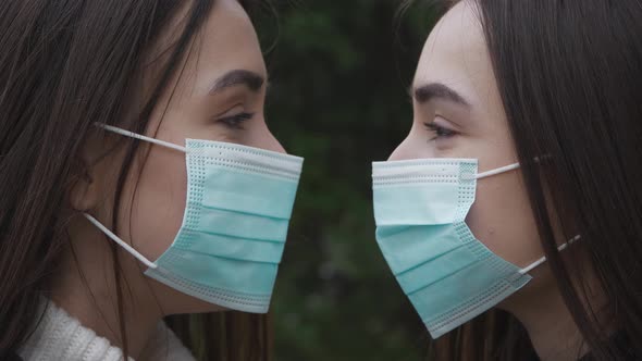 Portrait two caucasian twin girls in medical protective face mask. Outbreak of coronavirus COVID-19.