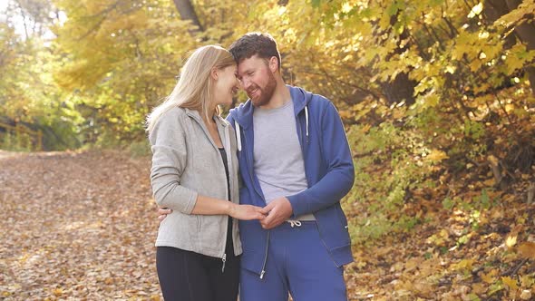 Caucasian Couple Happy Together, Young Couple Enjoying Each Other in the Autumn Forest on a Sunny alt