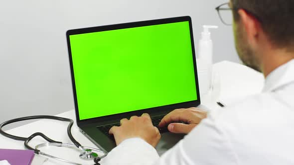 Close-up of Doctor Using Chromakey Laptop While Work alt