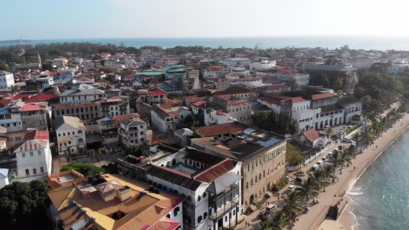 Aerial Stone Town Embankment with Palms Slums African Old Buildings Zanzibar alt