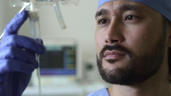 Male Nurse Checking IV Drip alt