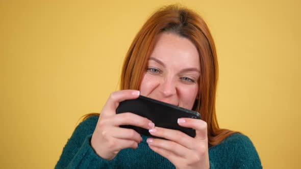 Young Red Hair Woman Posing Isolated on Yellow Color Background Studio alt