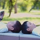 Two Boys Play on Smartphones During an Outdoor Walk - VideoHive Item for Sale