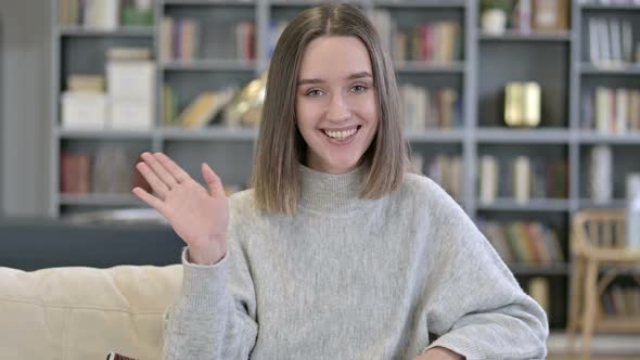 Portrait of Young Woman Waving on Video Chat alt