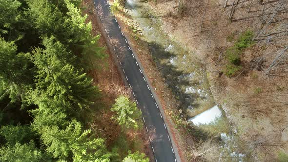 Aerial View of Road near Water and Forest alt
