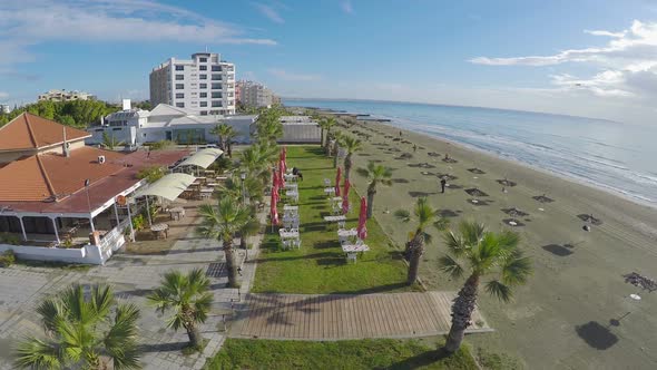 Aerial Drone Footage Video of Beach with Straw Parasols and Cafes, Larnaca City alt