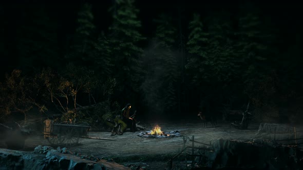 A man sitting by the fire at night