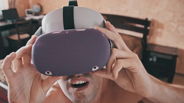 Young Man With a Naked Torso for the First Time in Virtual Reality Glasses alt
