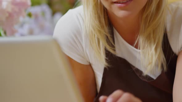 Flower Shop Assistant Working on Laptop alt
