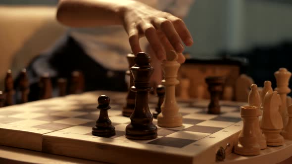 Young girl plays chess. Queen's move to avoid checkmate