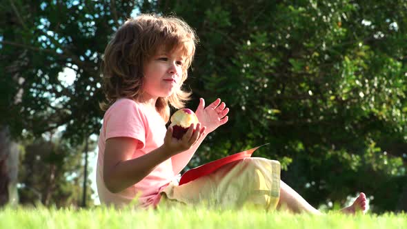 Boy Eating Fresh Apple Outdoor alt