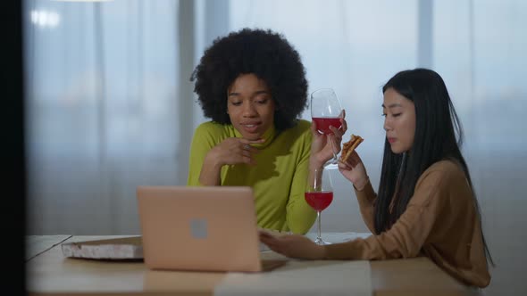 Beautiful African American and Asian Women Surfing Social Media Talking and Smiling Drinking Red alt