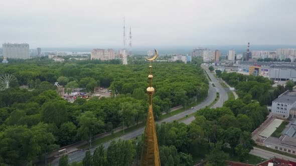 Top of Minaret of Mosque with Golden Crescent, Symbol of Islam, Closeup Aerial Shot