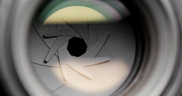 Closeup shot of professional camera lens, adjusting aperture alt