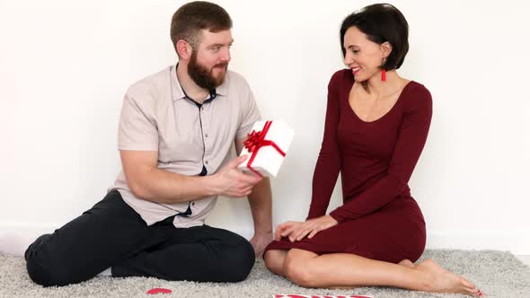 Husband and wife giving Valentines gifts.