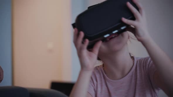 Cute Girl Is Using Cyber Futuristic Technology of Virtual Augmented Reality for Joy, Fun