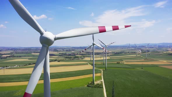 Aerial flight near wind turbines. Clear renewable energy production 4k Sky drone footage