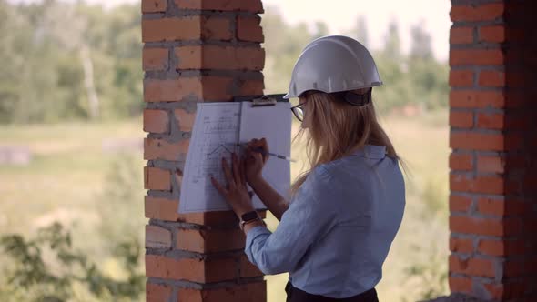 Real Estate Building Project Manager. Woman Architect In Helmet Inspecting Building. Civil Engineer. alt