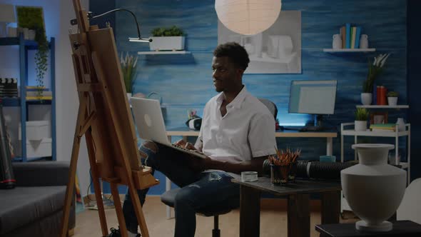 Black Creative Artist with Laptop Using Technology for Art Design alt