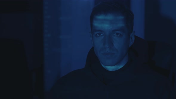 IT Hacker Programmer Developer Working on Computer Cyber Attack on Server at Night alt