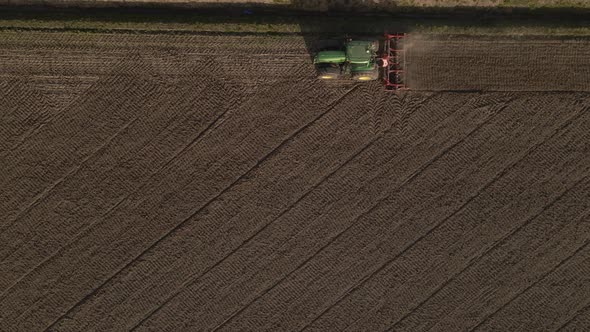 Topdown shot follow tractor plowing along the field, Agricultural environment alt