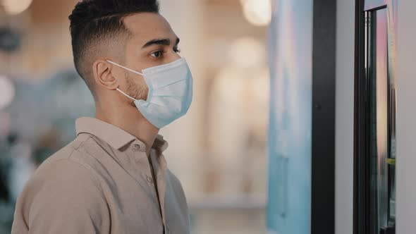 Arabian Indian Man in Medical Mask Choosing Via Selfservice Machine at Fast Food Restaurant alt