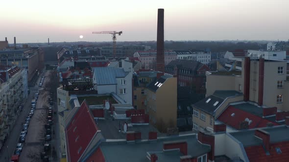 AERIAL: Flight Over Beautiful Berlin Neighbourhood Rooftop Cityscape During Sunset  alt