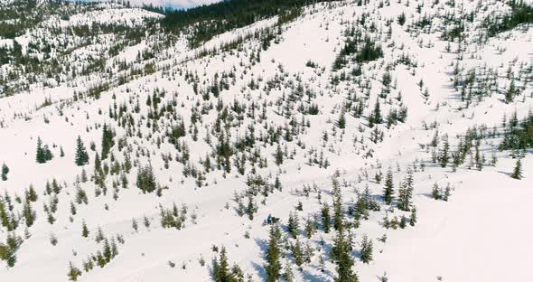 Snowmobile Follow Aerial Drone Shot Man Drives Uphill Mountain Slope Extreme Winter alt