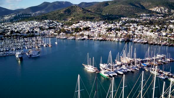 View from drone on full of yachts Bodrum harbour and ancient Kalesi castle in Mugla in Turkey alt