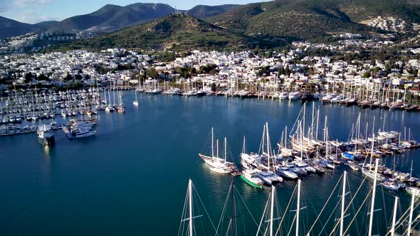 View from drone on full of yachts Bodrum harbour and ancient Kalesi castle in Mugla in Turkey