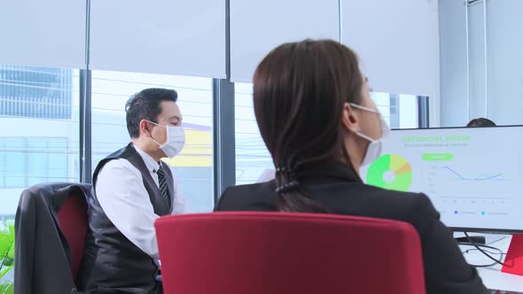 Businesspeople with face masks in the office during COVID-19 pandemic alt