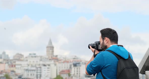 A Young guy is excitedly taking photos of tourist attractions near Galata Tower